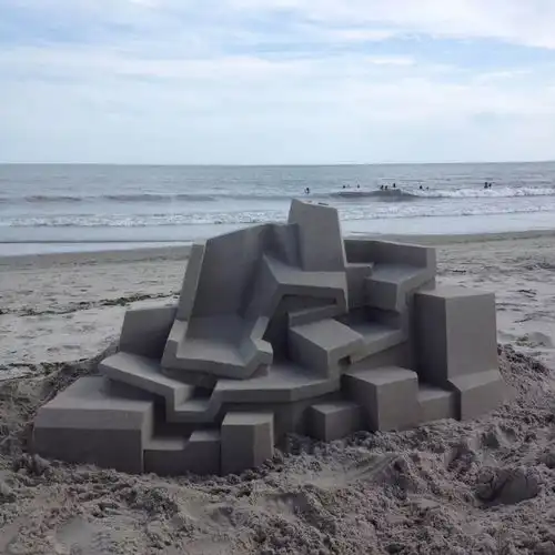 他用沙子在海滩上建了一座座海景房